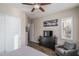 Comfortable bedroom with a ceiling fan, a dresser with TV, and a comfortable chair for relaxing at 12231 S 185Th Ave, Goodyear, AZ 85338