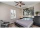 Serene bedroom with a ceiling fan, a neutral color scheme, and a comfortable chair for relaxing at 12231 S 185Th Ave, Goodyear, AZ 85338