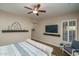 Bedroom with a TV, chair, and decorative shelves at 12231 S 185Th Ave, Goodyear, AZ 85338