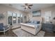 Serene bedroom with tufted headboard, plantation shutters, and soft, neutral tones at 12231 S 185Th Ave, Goodyear, AZ 85338