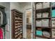 Well-organized closet with shoe racks and storage baskets, leading to a bathroom area at 12231 S 185Th Ave, Goodyear, AZ 85338