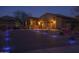 Beautiful home exterior at dusk, with desert landscaping, driveway lights, and a charming courtyard entrance at 12231 S 185Th Ave, Goodyear, AZ 85338