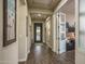 Welcoming foyer with decorative front door and views to a home office at 12231 S 185Th Ave, Goodyear, AZ 85338