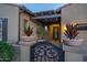 Inviting front entrance featuring a decorative iron gate and manicured landscaping at 12231 S 185Th Ave, Goodyear, AZ 85338