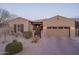 Charming single-story home features a tile roof, two-car garage, gated front entry and desert landscaping at 12231 S 185Th Ave, Goodyear, AZ 85338