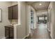 Hallway featuring dark wood floors, dark cabinets, and a view to the living area with outdoor views at 12231 S 185Th Ave, Goodyear, AZ 85338