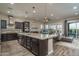 Modern kitchen featuring stainless steel appliances, granite countertops, and an island with pendant lighting at 12231 S 185Th Ave, Goodyear, AZ 85338