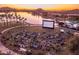 Outdoor movie night on the lawn by the lake with attendees enjoying the community event at 12231 S 185Th Ave, Goodyear, AZ 85338