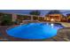 Backyard swimming pool with integrated waterfall feature and fire pit under a gazebo at 12231 S 185Th Ave, Goodyear, AZ 85338