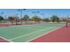 Community tennis court with well-maintained green and red surface, surrounded by landscaping at 12231 S 185Th Ave, Goodyear, AZ 85338