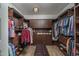 Organized walk-in closet with custom cabinetry, drawers, and open storage for clothing and accessories at 12231 S 185Th Ave, Goodyear, AZ 85338