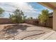 Backyard features brick pavers, mature trees, and a block fence at 12509 W Whyman St, Avondale, AZ 85323