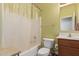 Standard bathroom featuring a shower-tub combo with a plastic curtain, toilet, and a single sink at 12509 W Whyman St, Avondale, AZ 85323