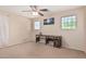 Bedroom with two windows and a dark wooden desk with natural light at 12509 W Whyman St, Avondale, AZ 85323