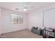 Bedroom with a window, light-colored carpet, and a table with books and some miscellaneous objects at 12509 W Whyman St, Avondale, AZ 85323