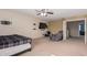 Bedroom with neutral walls, carpet, ceiling fan, furniture, and a wall-mounted television at 12509 W Whyman St, Avondale, AZ 85323