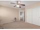 Bedroom featuring carpeted floors, a double closet, and plenty of open space at 12509 W Whyman St, Avondale, AZ 85323