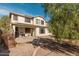 Two story home exterior with neutral paint, brick pavers, and mature trees at 12509 W Whyman St, Avondale, AZ 85323