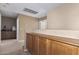 Bright hallway features built in wood cabinets, neutral paint and carpet at 12509 W Whyman St, Avondale, AZ 85323