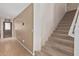 Hallway and staircase leading to the upper level of the home with carpeted stairs at 12509 W Whyman St, Avondale, AZ 85323