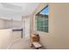 Hallway features a large window, neutral carpet, neutral paint, and a built in bench at 12509 W Whyman St, Avondale, AZ 85323