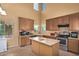 Bright kitchen with an island, and tile flooring at 12509 W Whyman St, Avondale, AZ 85323