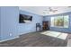 Bright living room with a ceiling fan, dark flooring, and comfortable gray couches at 12509 W Whyman St, Avondale, AZ 85323