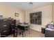 Home office features a work desk, black filing cabinet and ample lighting from the bright window at 12509 W Whyman St, Avondale, AZ 85323