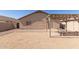 Desert backyard featuring a covered patio, a small table and a rock area at 1375 S 225Th Ln, Buckeye, AZ 85326