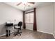 Cozy bedroom with a fan, wood-look flooring, desk, and a window for natural light at 1375 S 225Th Ln, Buckeye, AZ 85326