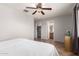 Comfortable bedroom with ceiling fan offering access to the ensuite bathroom and walk-in closet at 1375 S 225Th Ln, Buckeye, AZ 85326