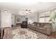 Bright living room with cozy seating, ceiling fan, and ample natural light creates a welcoming atmosphere at 1375 S 225Th Ln, Buckeye, AZ 85326