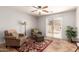 Relaxing living space with plush armchairs, a cozy rug, and sliding glass door to the outdoor patio at 1375 S 225Th Ln, Buckeye, AZ 85326