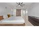 Comfortable bedroom with a ceiling fan, wooden bed, and a rustic sliding barn door at 1409 E Verlea Dr, Tempe, AZ 85282