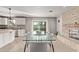 Bright dining room with a modern glass table, seating for eight, and stylish stone fireplace at 1409 E Verlea Dr, Tempe, AZ 85282