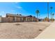 Single-story brick home with gravel landscaping, two car garage, and a palm tree at 1409 E Verlea Dr, Tempe, AZ 85282