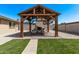 Outdoor gazebo with comfortable lounge chairs and a cozy fireplace, nestled in a landscaped backyard at 1409 E Verlea Dr, Tempe, AZ 85282