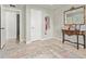 Hallway with light walls, doors, decorative rug, antique table, mirror, and wall art at 1409 E Verlea Dr, Tempe, AZ 85282