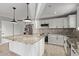 Contemporary kitchen featuring white cabinets, a granite island, and stainless steel appliances at 1409 E Verlea Dr, Tempe, AZ 85282