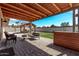 Back patio with pergola, stone pavers, seating, planters and outdoor kitchen area at 1409 E Verlea Dr, Tempe, AZ 85282