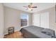 Bedroom featuring a window with blinds, a ceiling fan and closet for convenient storage at 1430 W Rockwood Dr, Phoenix, AZ 85027