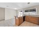 Bright kitchen featuring tile floors, wood cabinets, granite countertops, and sliding glass doors to the backyard at 1430 W Rockwood Dr, Phoenix, AZ 85027