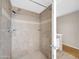 Tile shower enclosure with adjustable shower head and a small in-wall soap shelf at 1430 W Rockwood Dr, Phoenix, AZ 85027