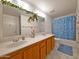 Well-lit bathroom with a double sink vanity and a decorative mirror at 145 N 74Th St # 256, Mesa, AZ 85207