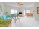 Bright living room featuring tropical-patterned sofas, ceiling fan, and a dining area at 145 N 74Th St # 256, Mesa, AZ 85207