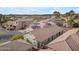 Aerial view showcases desert homes with solar panels and tile roofs in community at 16611 N 19Th St, Phoenix, AZ 85022