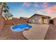 Backyard pool with desert landscaping, rock features, and a covered patio at 16611 N 19Th St, Phoenix, AZ 85022