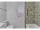 Stylish bathroom featuring decorative tile in shower with convenient inset shelving and a bright window at 16611 N 19Th St, Phoenix, AZ 85022