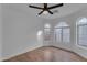 Bright bedroom features wood floors, arched windows, and a modern ceiling fan for added comfort at 16611 N 19Th St, Phoenix, AZ 85022