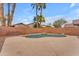 Backyard with pool featuring natural stone accents, palm trees, and privacy fence at 16611 N 19Th St, Phoenix, AZ 85022